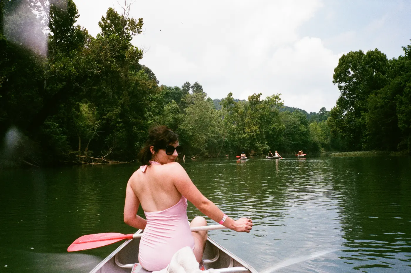 Paddling downriver in a pink swimsuit