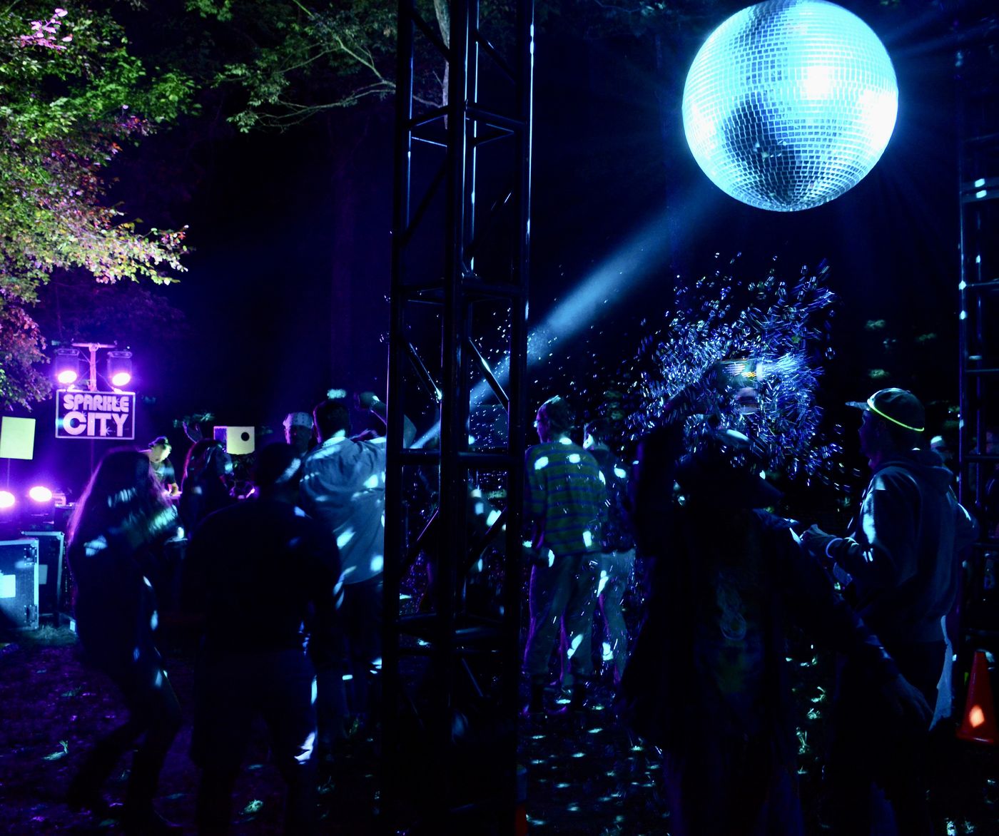 Disco ball scattering blue light over the crowd
